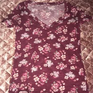A maroon shirt with flowers